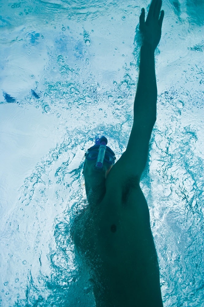 Swimmer using a breathing snorkel